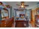 Comfortable bedroom with blue walls, wood floors and a ceiling fan, providing a relaxing atmosphere at 1439 Wetherington Way, Palm Harbor, FL 34683