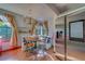 Sunlit breakfast nook with a charming built-in bench, coordinating blue and white patterns, and stainless steel refrigerator nearby at 1439 Wetherington Way, Palm Harbor, FL 34683