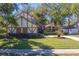 Charming home with a well-manicured lawn and mature landscaping, featuring classic architectural design at 1439 Wetherington Way, Palm Harbor, FL 34683