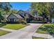 Charming two-story Tudor-style home with lush lawn and mature trees at 1439 Wetherington Way, Palm Harbor, FL 34683