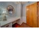 Hallway features a built-in vanity, floral wallpaper, and access to a private area at 1439 Wetherington Way, Palm Harbor, FL 34683