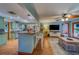 An open layout featuring a seamless design between the kitchen and living room area with breakfast bar at 1439 Wetherington Way, Palm Harbor, FL 34683