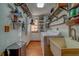 Practical laundry room with wood floors, sink, and shelving, providing ample storage and functionality at 1439 Wetherington Way, Palm Harbor, FL 34683