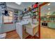 Well-organized laundry room with washer, dryer, utility sink, wood shelving, and view into the kitchen at 1439 Wetherington Way, Palm Harbor, FL 34683