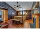 A luxurious bedroom with a four poster bed, fireplace, and unique plaid wallpaper at 1439 Wetherington Way, Palm Harbor, FL 34683