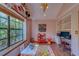 Cozy playroom with playful decor, natural light, and dedicated study area with view to front yard at 1439 Wetherington Way, Palm Harbor, FL 34683