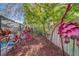 Lush garden path decorated with vibrant metal sculptures with a view of the screened-in pool at 1439 Wetherington Way, Palm Harbor, FL 34683
