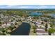The property overlooks a serene pond in a well-maintained community from this aerial view at 15616 Greyrock Dr, Spring Hill, FL 34610