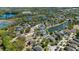 Aerial view of a lakeside neighborhood with homes surrounded by trees at 15616 Greyrock Dr, Spring Hill, FL 34610