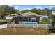 A screened-in pool and a white vinyl privacy fence in the backyard create a private outdoor space at 15616 Greyrock Dr, Spring Hill, FL 34610