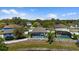 An aerial view of the backyard shows the screened-in pool and white vinyl privacy fence at 15616 Greyrock Dr, Spring Hill, FL 34610