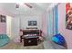 Cozy bedroom featuring pink walls, a ceiling fan, and decor including posters on the wall at 15616 Greyrock Dr, Spring Hill, FL 34610