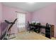 Bedroom features a treadmill, desk, and carpet at 15616 Greyrock Dr, Spring Hill, FL 34610