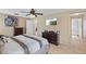 Inviting bedroom with a comfortable bed, contemporary decor, and a doorway leading to the adjoining bathroom at 15616 Greyrock Dr, Spring Hill, FL 34610
