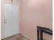 Clean entryway featuring a white door, pink walls, and tiled floor at 15616 Greyrock Dr, Spring Hill, FL 34610