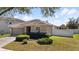 Beautifully landscaped front yard of a single-story home with a spacious driveway and attached two-car garage at 15616 Greyrock Dr, Spring Hill, FL 34610
