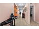Hallway featuring tile floors, light pink walls, and decorative elements at 15616 Greyrock Dr, Spring Hill, FL 34610