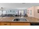 Open-concept kitchen features a central island with a stainless steel sink, fostering connectivity with living spaces at 15616 Greyrock Dr, Spring Hill, FL 34610