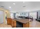 Open-concept kitchen boasts an island with stainless sink, seamlessly connecting to the living and dining areas at 15616 Greyrock Dr, Spring Hill, FL 34610