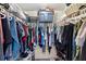 Organized walk-in closet featuring clothing racks, shelves, and storage solutions, maximizing space and functionality at 15616 Greyrock Dr, Spring Hill, FL 34610