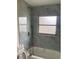 Upgraded bathroom showcasing stylish marble tiling, a modern shower head, and bathtub fixtures at 1606 Marilyn Ave, Bradenton, FL 34207