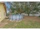 Backyard showcasing an above-ground pool and mature trees, creating a private outdoor space at 1617 Cherokee Trl, Valrico, FL 33594