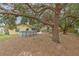 Spacious backyard with a pool, patio, and mature trees, perfect for outdoor entertaining and relaxation at 1617 Cherokee Trl, Valrico, FL 33594