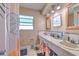 Bathroom features double sinks, and well-lit vanity mirrors and a shower with curtain at 1617 Cherokee Trl, Valrico, FL 33594