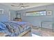Blue bedroom with a ceiling fan, wood flooring, a window, and natural light at 1617 Cherokee Trl, Valrico, FL 33594