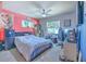 Cozy bedroom with a ceiling fan, mini fridge, and large windows at 1617 Cherokee Trl, Valrico, FL 33594