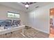Bedroom with wood-look flooring, ceiling fan, closet and natural light at 1617 Cherokee Trl, Valrico, FL 33594
