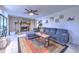 Welcoming living room features tile flooring, a comfortable sectional sofa, and a beautiful stone fireplace, perfect for relaxing at 1617 Cherokee Trl, Valrico, FL 33594