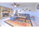 Inviting living room with tile flooring, a comfortable sectional sofa, and a charming stone fireplace creating a warm ambiance at 1617 Cherokee Trl, Valrico, FL 33594