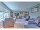 Inviting living room featuring hardwood floors, comfortable seating, and plenty of natural light from the large window at 1617 Cherokee Trl, Valrico, FL 33594