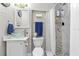 Cozy bathroom featuring modern fixtures, a unique glass sink, and a shower with a mosaic accent wall at 1653 S Prescott Ave, Clearwater, FL 33756