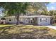 Charming single-story home with a well-maintained front yard and mature trees offering shade at 1653 S Prescott Ave, Clearwater, FL 33756