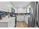 Bright kitchen with white cabinets, stainless steel appliances, and stylish backsplash at 1653 S Prescott Ave, Clearwater, FL 33756