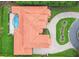 Aerial view of a luxury home with a tile roof, pool, and lush landscaping at 17005 Madres De Avila, Tampa, FL 33613