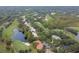 Aerial view of golf course and homes, showcasing landscaping, ponds, and serene community at 17005 Madres De Avila, Tampa, FL 33613
