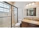 Modern bathroom features a glass shower, vanity with granite countertop and a large mirror at 17005 Madres De Avila, Tampa, FL 33613
