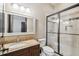 Bathroom with a granite countertop, wood vanity, and glass enclosed shower at 17005 Madres De Avila, Tampa, FL 33613