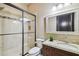 Bathroom with granite countertop, dark cabinets, and a large glass shower at 17005 Madres De Avila, Tampa, FL 33613