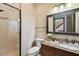 Bathroom featuring a granite countertop, and a glass door shower at 17005 Madres De Avila, Tampa, FL 33613