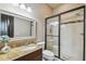 Modern bathroom with granite countertop, glass shower, and framed mirror at 17005 Madres De Avila, Tampa, FL 33613