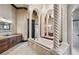 Luxurious bathroom featuring a jetted tub, columns, and dual vanity at 17005 Madres De Avila, Tampa, FL 33613