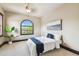 Bright bedroom featuring a bed with blue accents and a large arched window at 17005 Madres De Avila, Tampa, FL 33613
