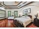 Elegant bedroom showcasing hardwood floors, decorative ceiling, and ornate furniture at 17005 Madres De Avila, Tampa, FL 33613