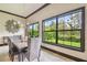 Dining room with chandelier, large windows, and views of the landscaped yard at 17005 Madres De Avila, Tampa, FL 33613