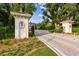 Entrance with gated entry, lush landscaping, and brick-paved road at 17005 Madres De Avila, Tampa, FL 33613