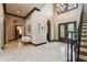Grand foyer with marble flooring, decorative columns, and a view of the staircase and ornate double doors at 17005 Madres De Avila, Tampa, FL 33613